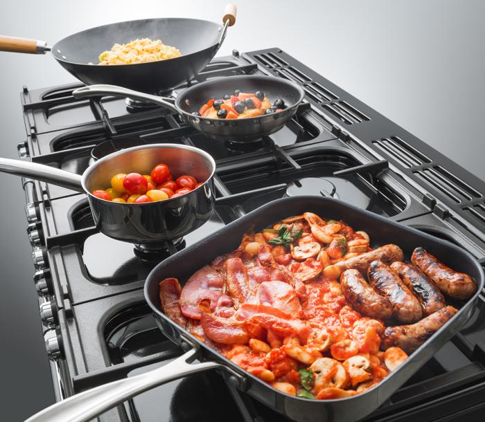Falcon Esprit Dual Fuel hob with pans with various contents